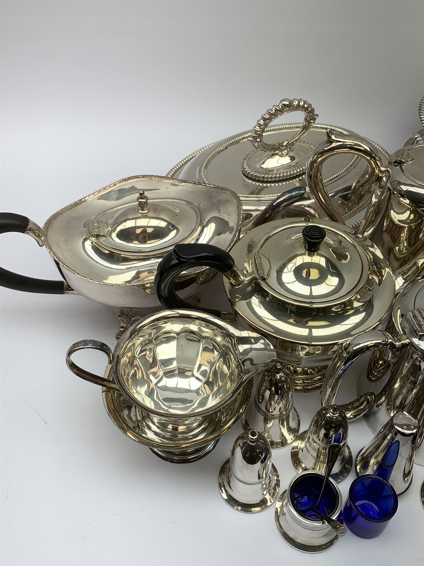 Mappin & Webb Art Deco style four-piece silver-plated tea set, a Mappin & Webb three-piece Princes Plate tea set of half fluted form with engraved monogram, two silver-plated entree dishes, circular tea tray, part cruets and other plated wares 