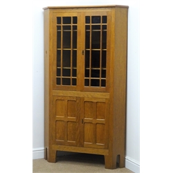  Yorkshire Oak - 'Acornman' corner cabinet, two astragal glazed doors, fitted with three shaped shelves, above two panelled doors, by Alan Grainger of Brandsby, York, W95cm, H169cm  