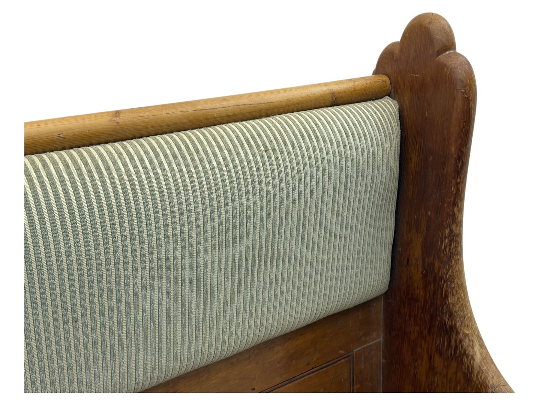 Early 20th century waxed pine pew, inset upholstered striped back panel with hinged box seat enclosing storage, shaped arms and turned supports