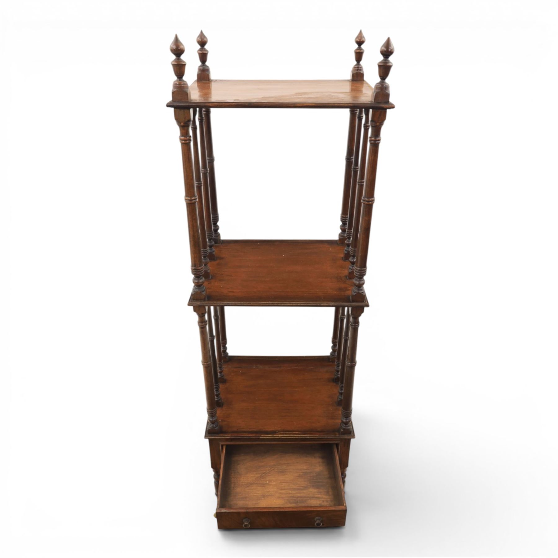 Late Victorian mahogany whatnot, the three tiers supported by turned spindle uprights with turned finials, fitted with a single frieze drawer, raised on turned supports with brass castors