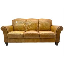 20th century traditional three seat sofa with rolled arms, upholstered in tan leather, on tapering feet