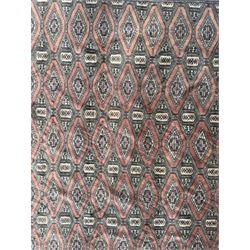 Large Persian Bokhara wool rug, the field decorated with repeating gul motifs in lozenge medallions across a dark ground, enclosed by multiple geometric borders in indigo, ivory and terracotta, from the region of Baluchistan