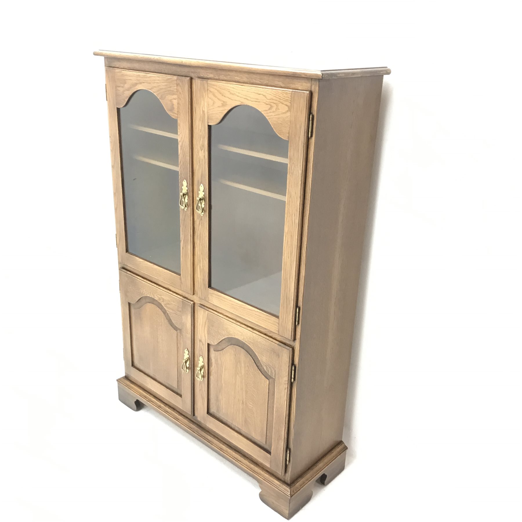 Jaycee - medium oak display cabinet, two glazed doors enclosing two shelves above two panelled cupboards, shaped bracket supports, W94cm, H140cm, D33cm