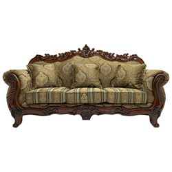 Italian Baroque design three seat sofa, hardwood framed, the cresting rail carved and pierced with c-scrolls and flower heads, scrolled arms, upholstered in floral patterned and striped fabric, with scatter cushions 