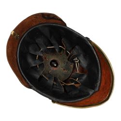 WWI Prussian guard regiment Pickelhaube, the black leather skull with brass ball finial, brass eagle helmet plate and leather chin strap, one side with a black  and white cockade, the other black, white and red, 