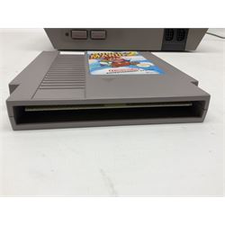 Nintendo Entertainment System (1985) console with two controllers, accessories and instruction booklet. NES Games ‘Duck Hunt’ with Nintendo Zapper gun, ‘Pinball’ and ‘Super Mario Bros.’, all with original sleeves and instruction booklets. NES game ‘Super Mario Bros. 2’ cartridge only