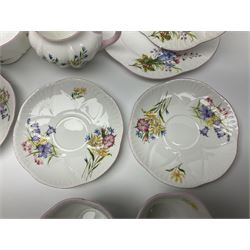 Shelley Wild Flowers pattern part tea service, comprising four cups and saucers, four dessert plates, cake plate, milk jug and open sucrier