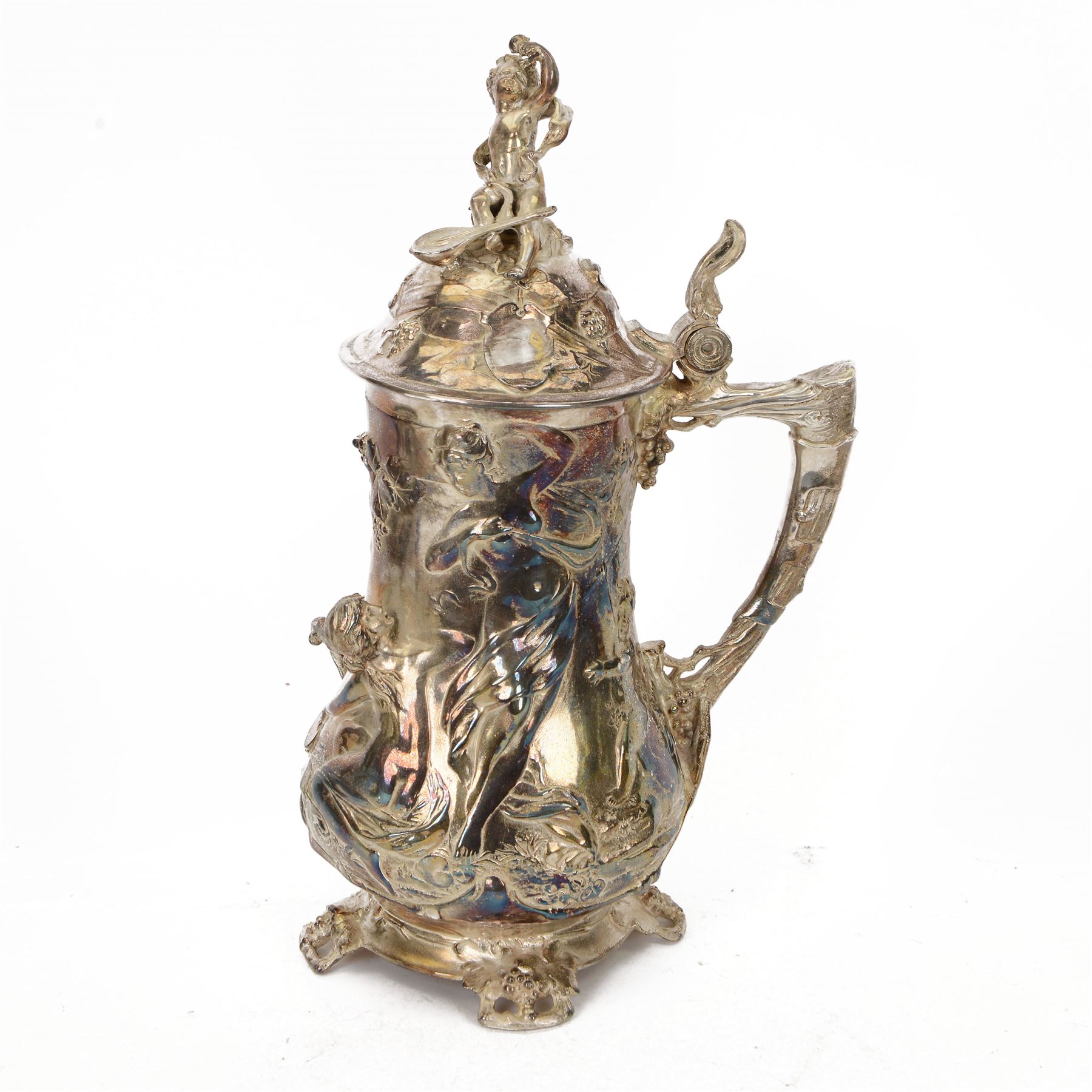 Large late 19th/early 20th century WMF Art Nouveau silver plated stein or jug, circa 1900, the bellied body cast and applied with Bacchanalian figures, the domed cover with putti finial, and handle modelled as a vine, the whole upon four fruit and leaf mounted feet, marked beneath for WMF and engraved with initials CHE and dated 1911, H40.5cm
