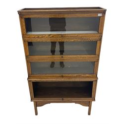 Early 20th century oak stacking library bookcase, in four sections (bottom pane lacking)