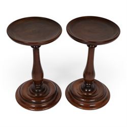 Pair of 19th century turned mahogany candle stands, each with circular top upon a baluster stem and circular stepped base, H25.5cm