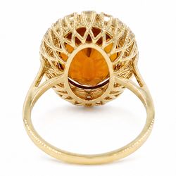 18ct gold citrine and diamond cluster ring, single oval cut citrine of approx 6.90 carat, surrounded by twenty round brilliant cut diamonds, stamped, total diamond weight approx 0.60 carat