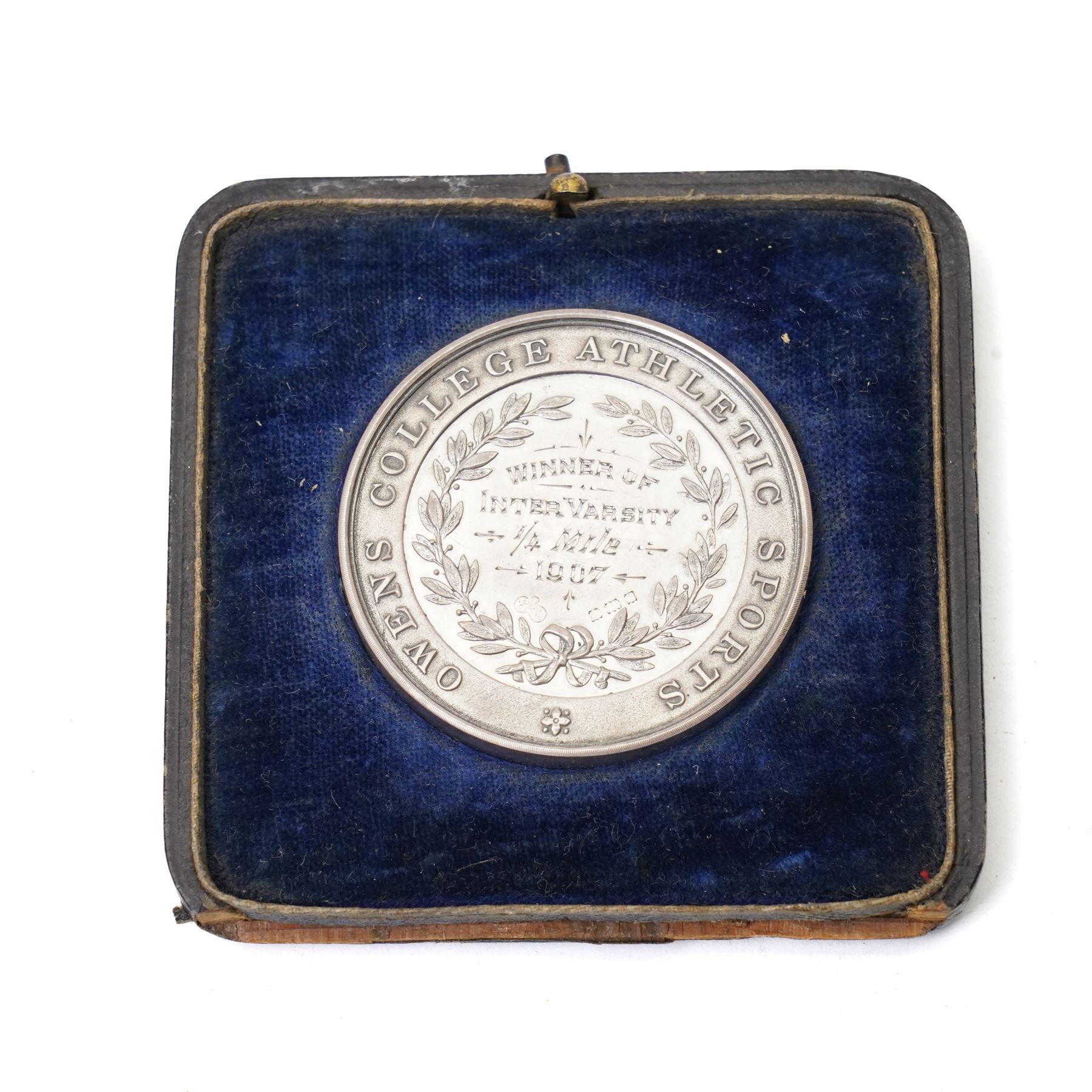 Group of early 20th century sporting medallions, fobs and badges, including two silver Inter Varsity 1/4 mile cased medallions, two silver fobs, white metal and enamel cricket fob etc, one awarded to John Barugh Fisher (1888-1924) born in Amotherby, studied at Leeds University and became doctor in 1911, later Captain John Barugh Fisher R.A.M.C., together with four early 20th century nurses badges, two for General Infirmary Leeds, three inscribed B.P. Simpson, housed in an inlaid work box