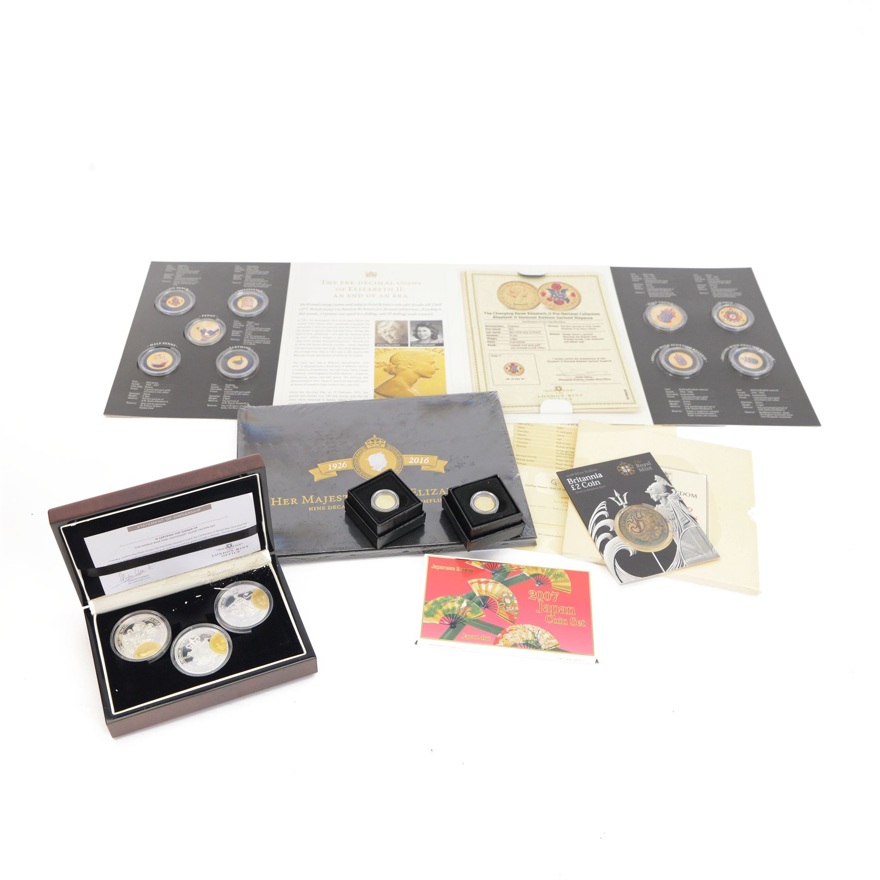 Two The London Mint Office 2009 9ct gold 1 gram half crown coins, Queen Elizabeth II Tristan Da Cunha 2014 'The World War One Centenary Silver Crown Set', The Royal Mint 2008 one ounce fine silver Britannia, United Kingdom 1986 brilliant uncirculated coin collection and other coins
