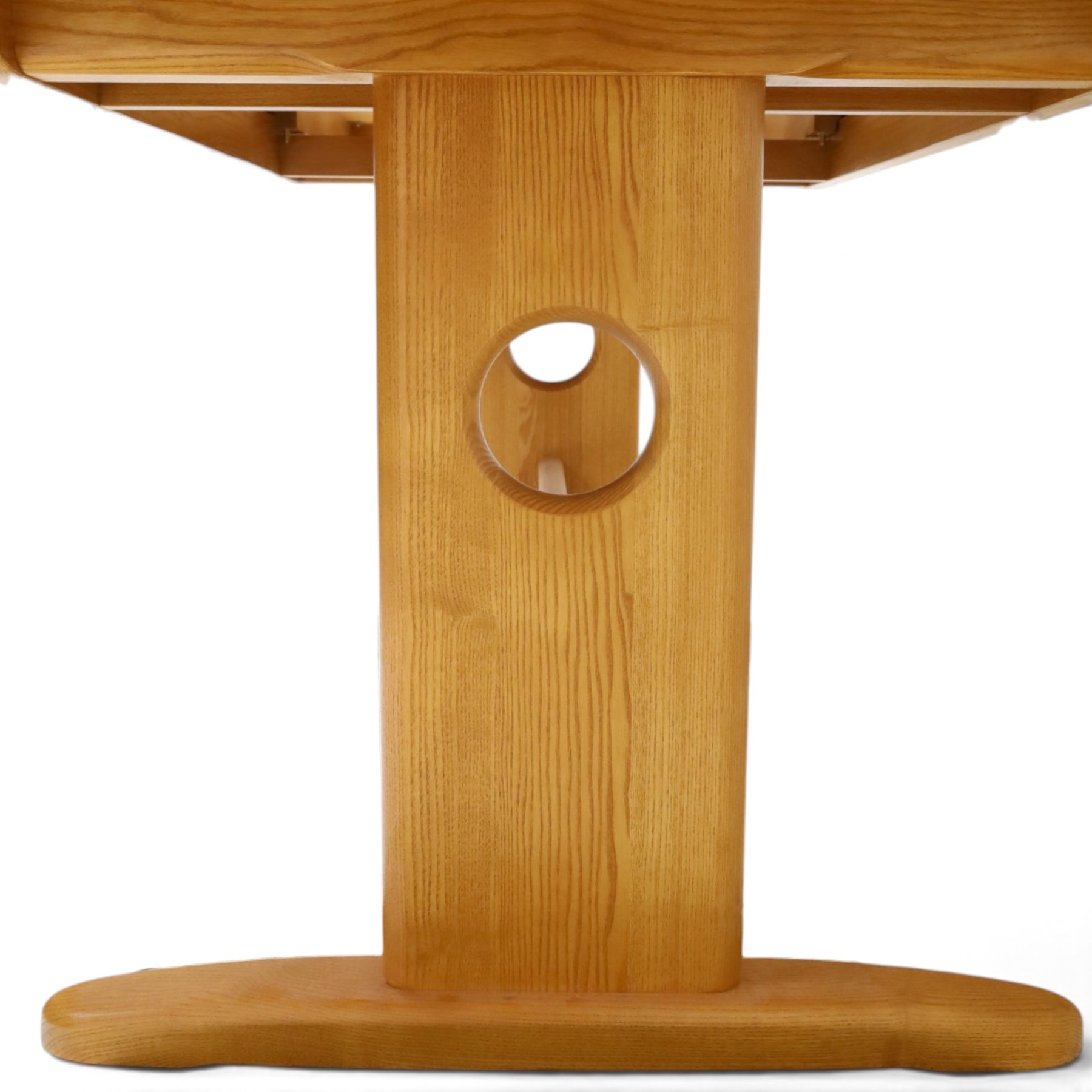 Ercol - 'Windsor' ash medium extending dining table, with stowed fold over leaf extending to 200cm, shaped supports with roundel aperture, united by a stretcher