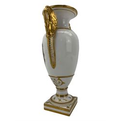 Early 19th century Derby vase, of campana urn form, decorated to one side with a hand painted reserve of a basket of flowers, within a scroll gilt border and twin serpent form handles, H20.5cm together with a Bloor Derby vase, hand painted with figures in a wooded landscape, with twin gilt swan form handles, upon a square pedestal foot, H25cm (2)