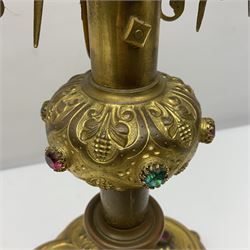 20th century gilt metal monstrance, in the Gothic revival style, with glazed aperture to centre surrounded with clear paste stones, in a pierced floral and scroll border set with coloured paste stones, within a sunburst surround, on a paste set knopped stem and similar foliate foot, H59.3cm