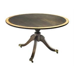 20th century mahogany and rosewood crossbanded circular tilt top dining table on turned column with four acanthus carved supports with brass capped hairy paw feet, by Gotts of Pickering, D122cm, H73cm