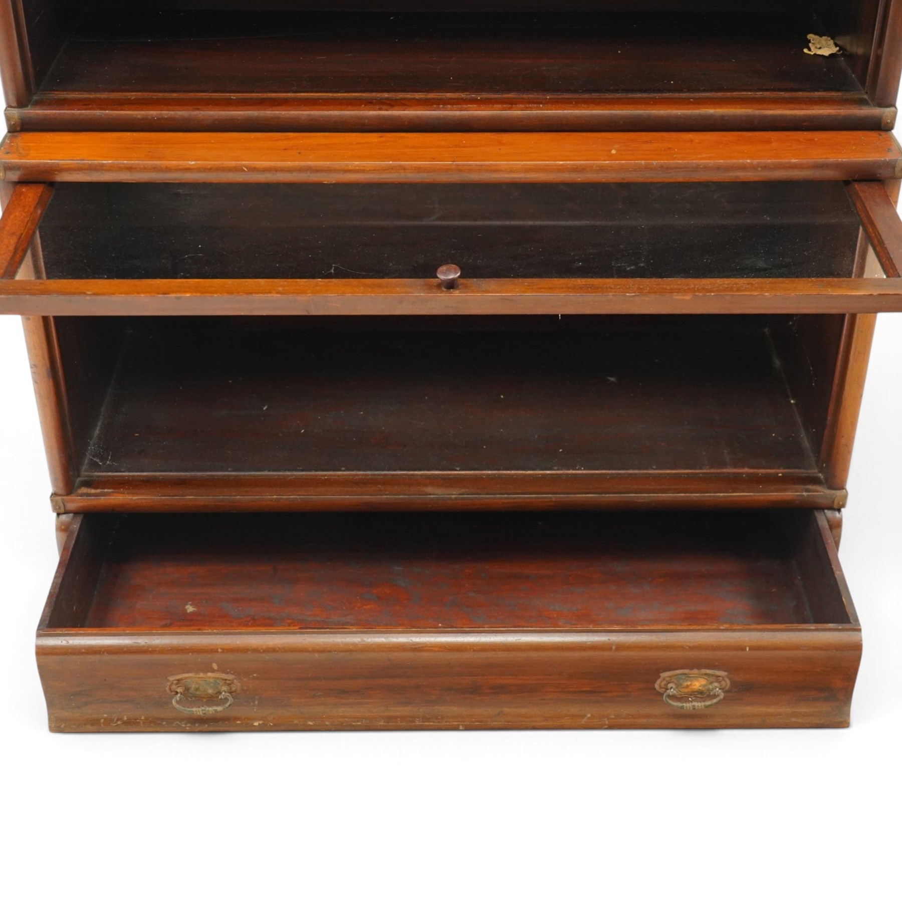 Globe Wernicke - early 20th century mahogany four-tier stacking library bookcase, the shelves fitted with glazed up-and-over doors, fitted with single drawer to the skirted base