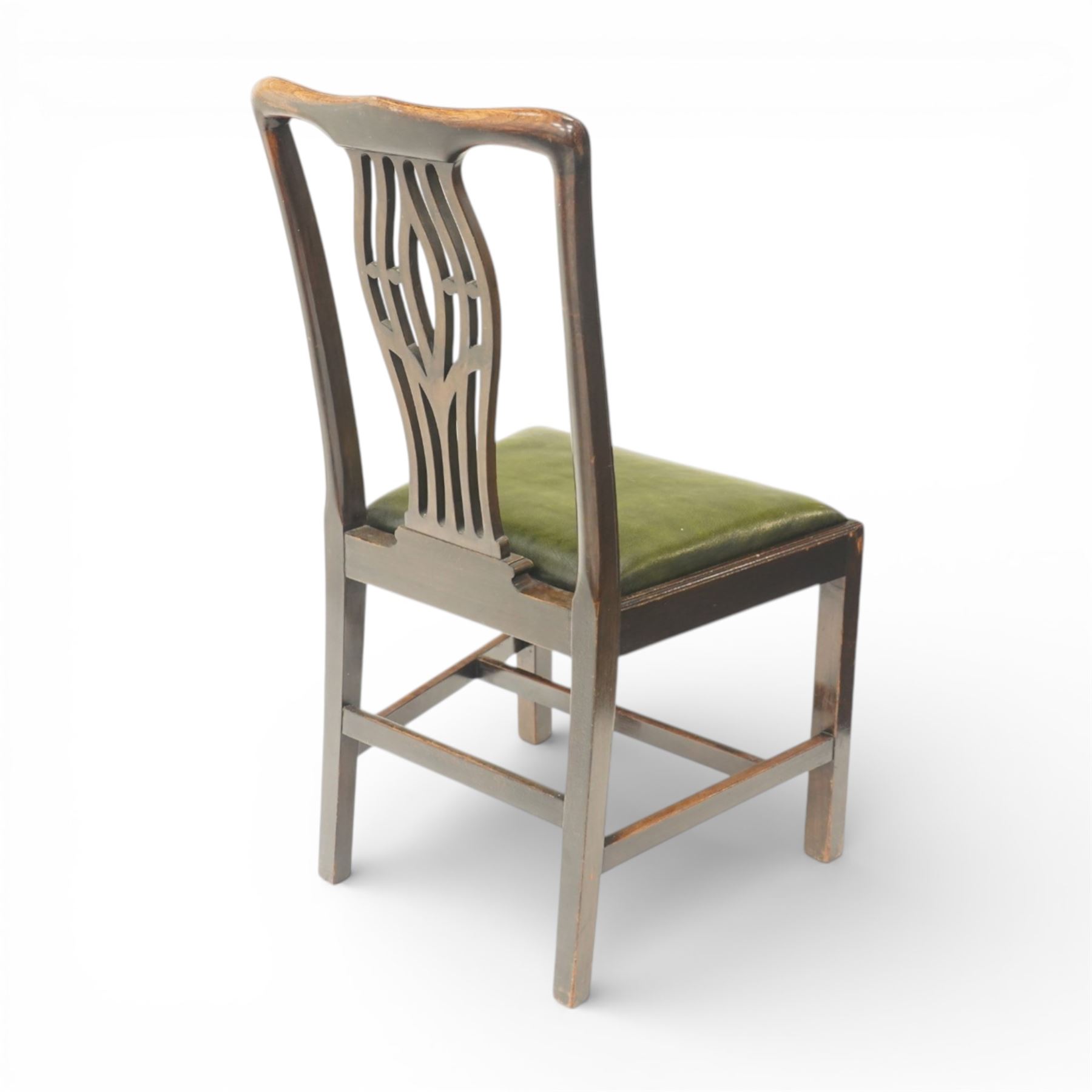Set of eight Georgian style mahogany dining chairs, comprising six chairs and two carvers, the shaped top rails above pierced vase splats, and green leather upholstered drop in seats, upon square legs united by stretchers
