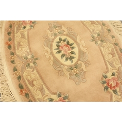  Chinese wool oval rug, worked with flowers on a pink ground, 145cm x 90cm  