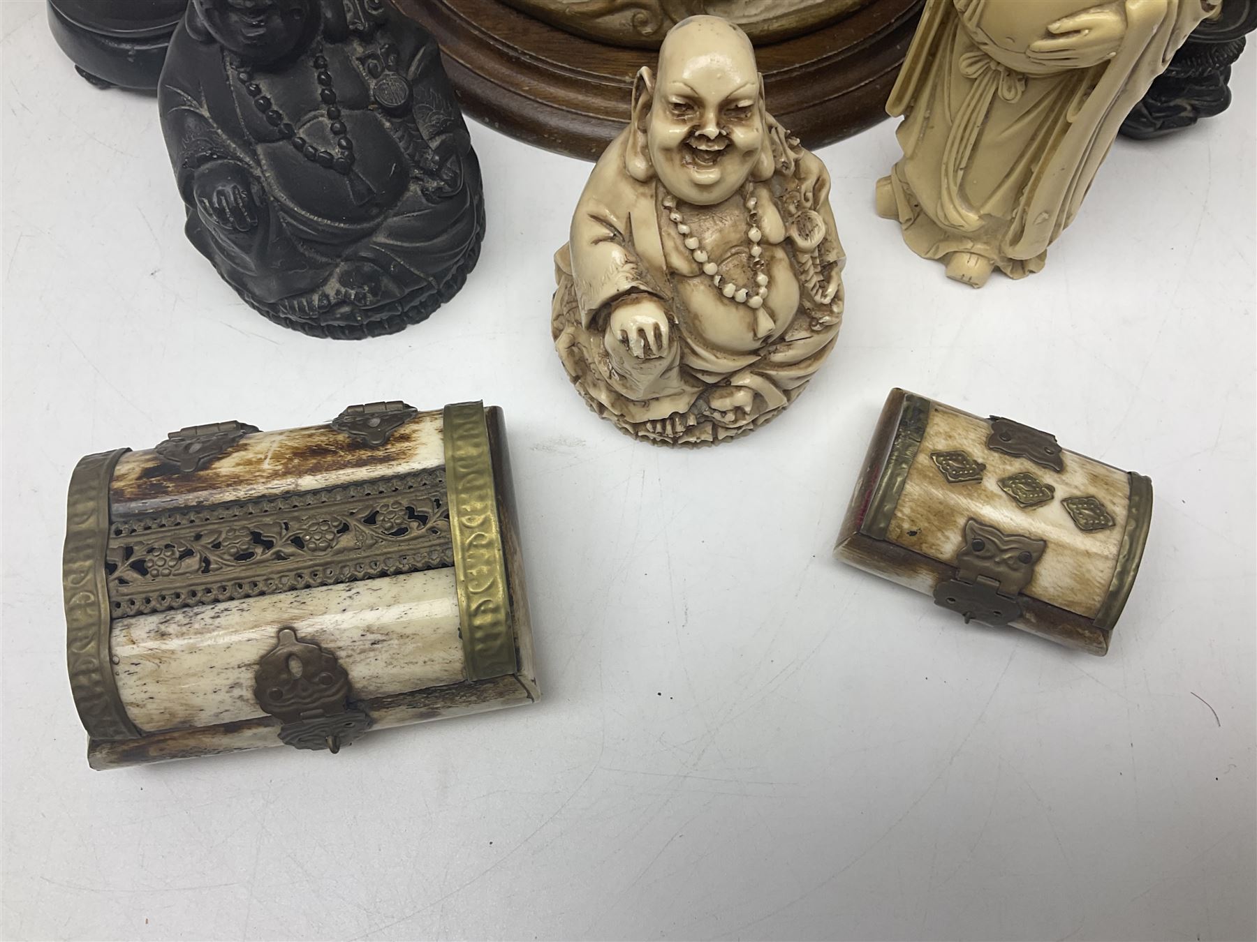 Composite figure of a couple upon a rearing horse, together with a collection of resin immortals and two bone chests 