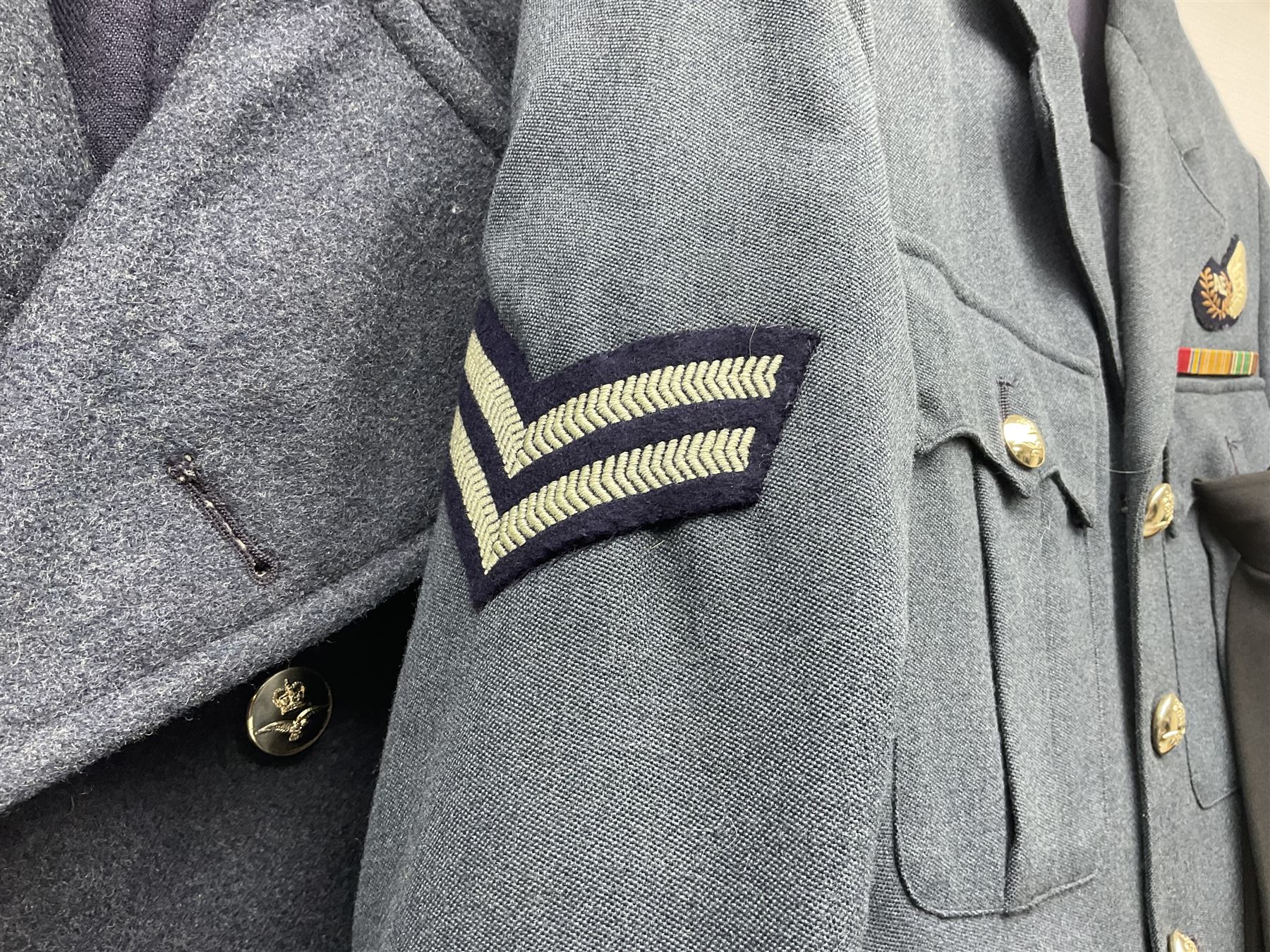 Two post-WWII British Army No.2 Dress tunics, one with Green Howards buttons; army shirt dated 1951; Royal Fleet Auxilliary jacket with trousers; three RAF/WAAF uniforms and RAF Greatcoat; and three canvas/webbing bags, two dated 1943 & 1945