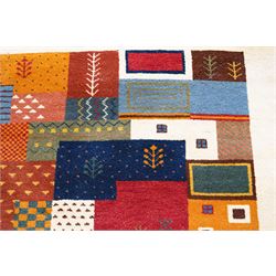 Persian style Gabbeh Loribaft design ivory ground rug, the vibrant field decorated with geometric patchwork design panels with interspersed stylised tree motifs, enclosed by a wide ivory guard band