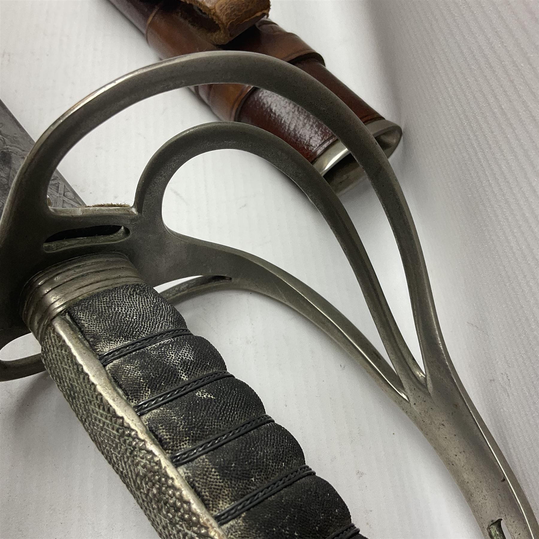 WWI 1821 pattern Royal Artillery officer's sword, the 82.5cm decorative blade by Hawksworth Sheffield etched with GVR cypher and crown, 'Royal Artillery' and field gun between scrolling foliate panels; three-bar hilt with wire-bound fish skin grip and chequered backstrap; in leather covered scabbard L99cm overall