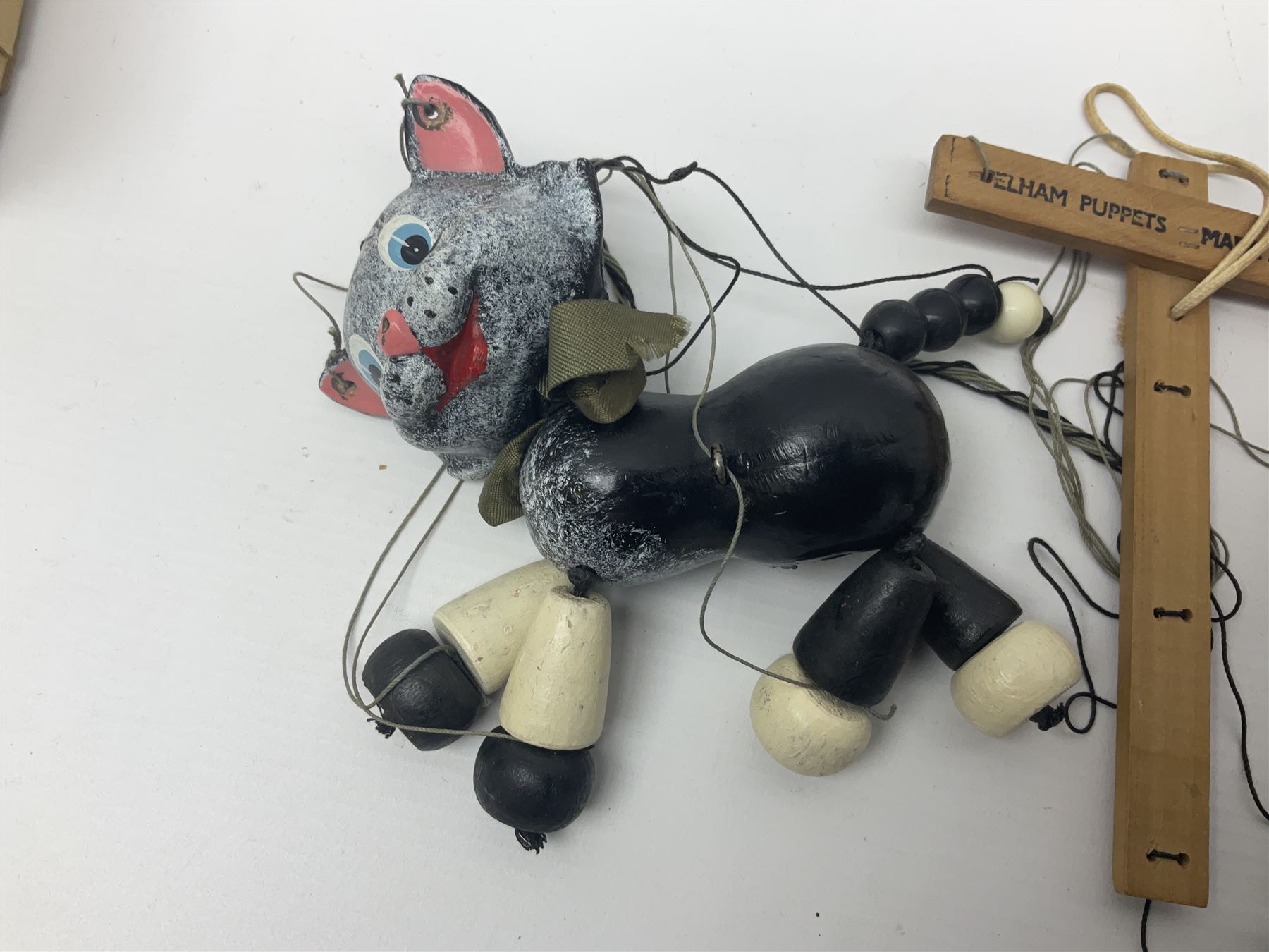 Pelham Puppet - three puppets comprising a painted wooden duck with felt mouth and wings with metal joints H12cm, in original box and instructions; and two further examples Type A cat with a hollow body H12cm, and a boy H23cm (3) 