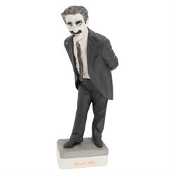 Two Spanish Algora Personajes Del Cine figures, modelled as Charlie Chaplin and Groucho Marx, with printed marks beneath, both with certificates of authenticity, H35cm