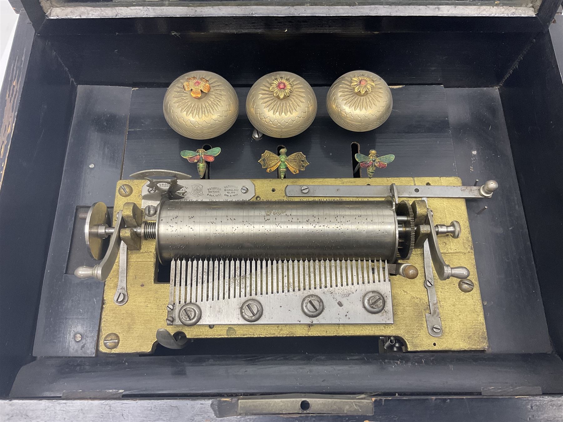 Swiss - 19th-century cylinder music box with three butterfly bells in sight, in a mahogany case with two separately boxed  6” cylinders, glazed viewing lid, 41 tooth comb (one tooth broken) crank key missing, movement untested.