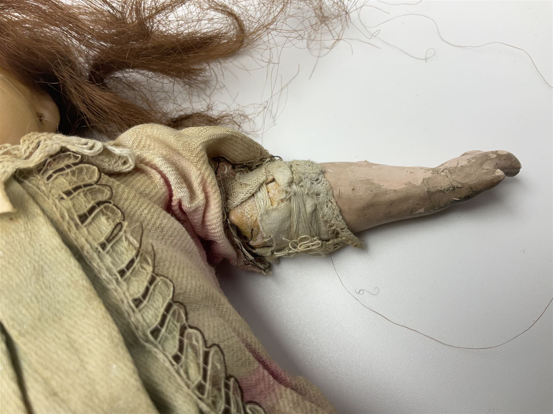 Victorian wax shoulder head doll with applied hair, inset glass eyes and jointed body with composition lower limbs; faded pink dress H35cm