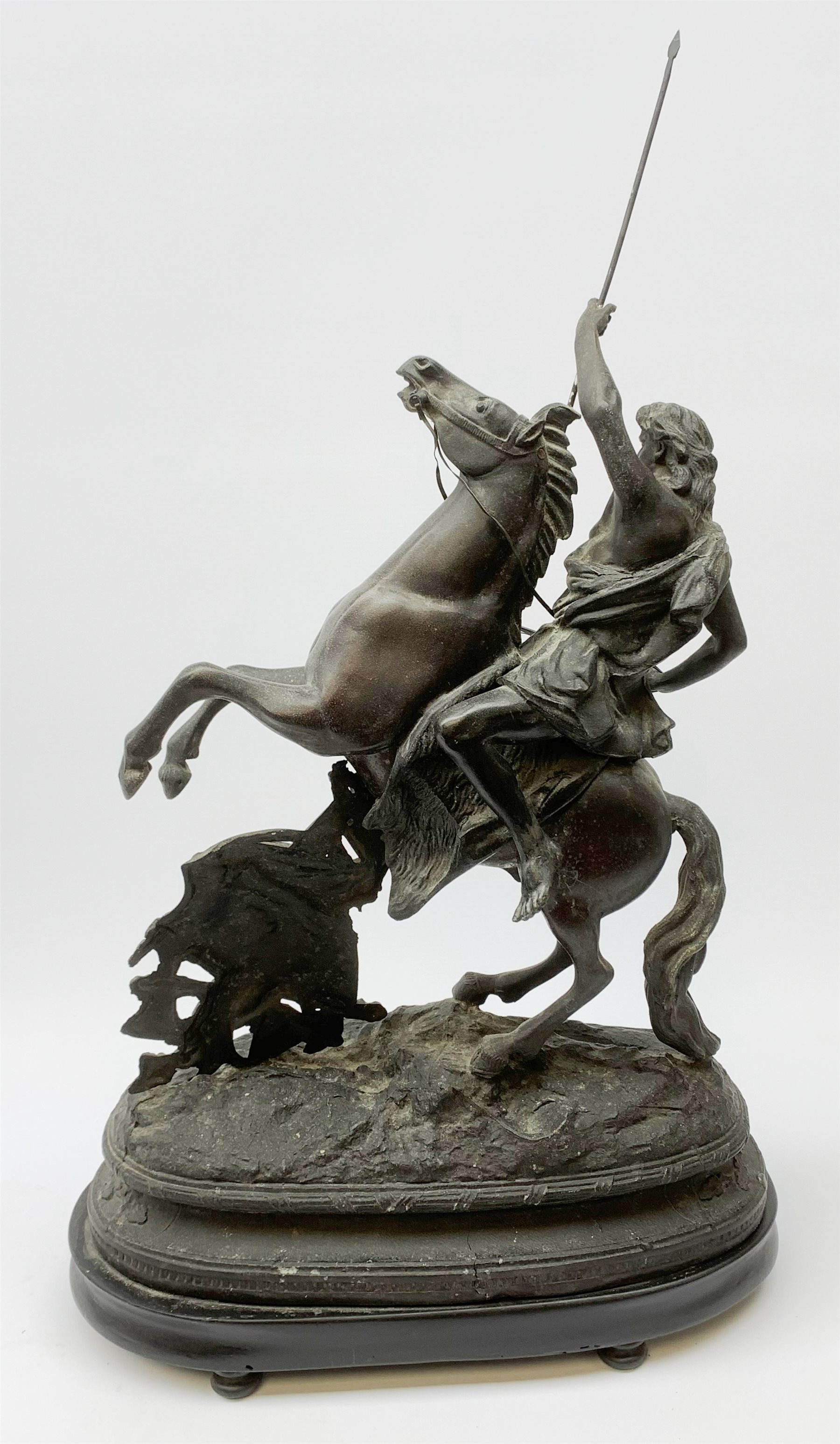 After Theodore Doriot, 19th century spelter figure of a barbarian warrior with spear and sword on a rearing horse, with battle trophies on the naturalistic base, H64cm including later ebonised wooden base
