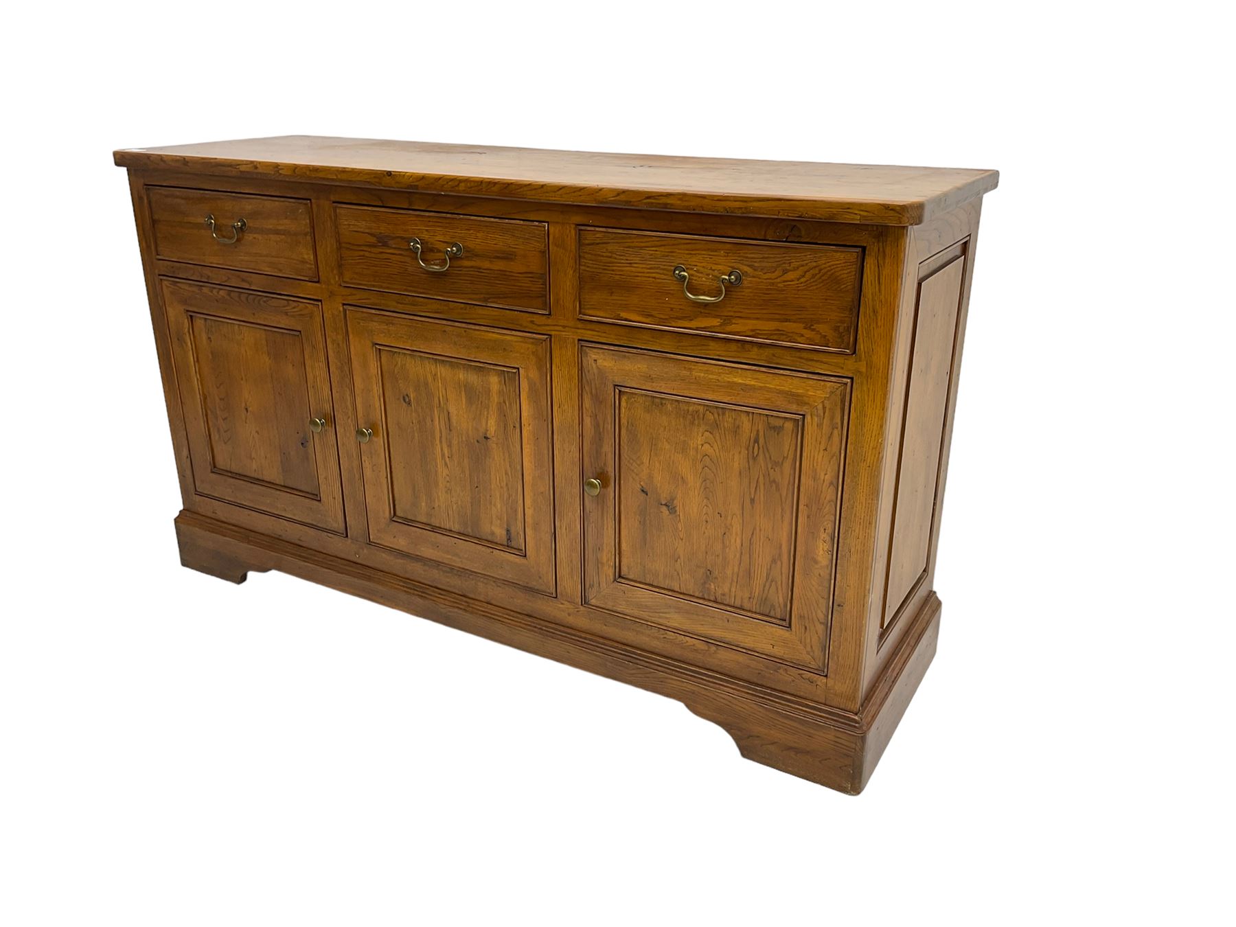 Willis & Gambier - oak sideboard, three drawers over three panelled cupboards, on bracket feet 