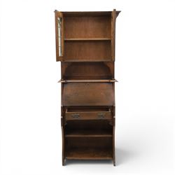 Arts & Crafts oak bureau bookcase, projecting cornice with leaded and glazed upper cabinet, the lower section with fall front section revealing a fitted interior, above shaped lower shelving 