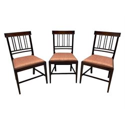 Early 20th century Regency design mahogany tilt-top table, circular top with edge banding, supported by a central turned pedestal with four reeded sabre supports terminating in castors; six chairs with pink upholstered drop in seats (7)