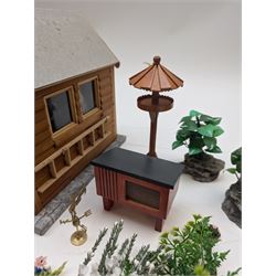 1:12 scale dolls house allotment and garden accessories, including wooden shed on a stone effect base, two vegetable patches, terracotta plant pots with flowers and foliage, stone effect plant pots, other planters, loose sunflowers, scarecrow, rabbit hutch, garden tools, fencing panels, etc 