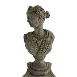 Classical design cast stone female bust depicting Artemis, raised on fluted Corinthian column with acanthus leaf capital, stepped square base, looking right 