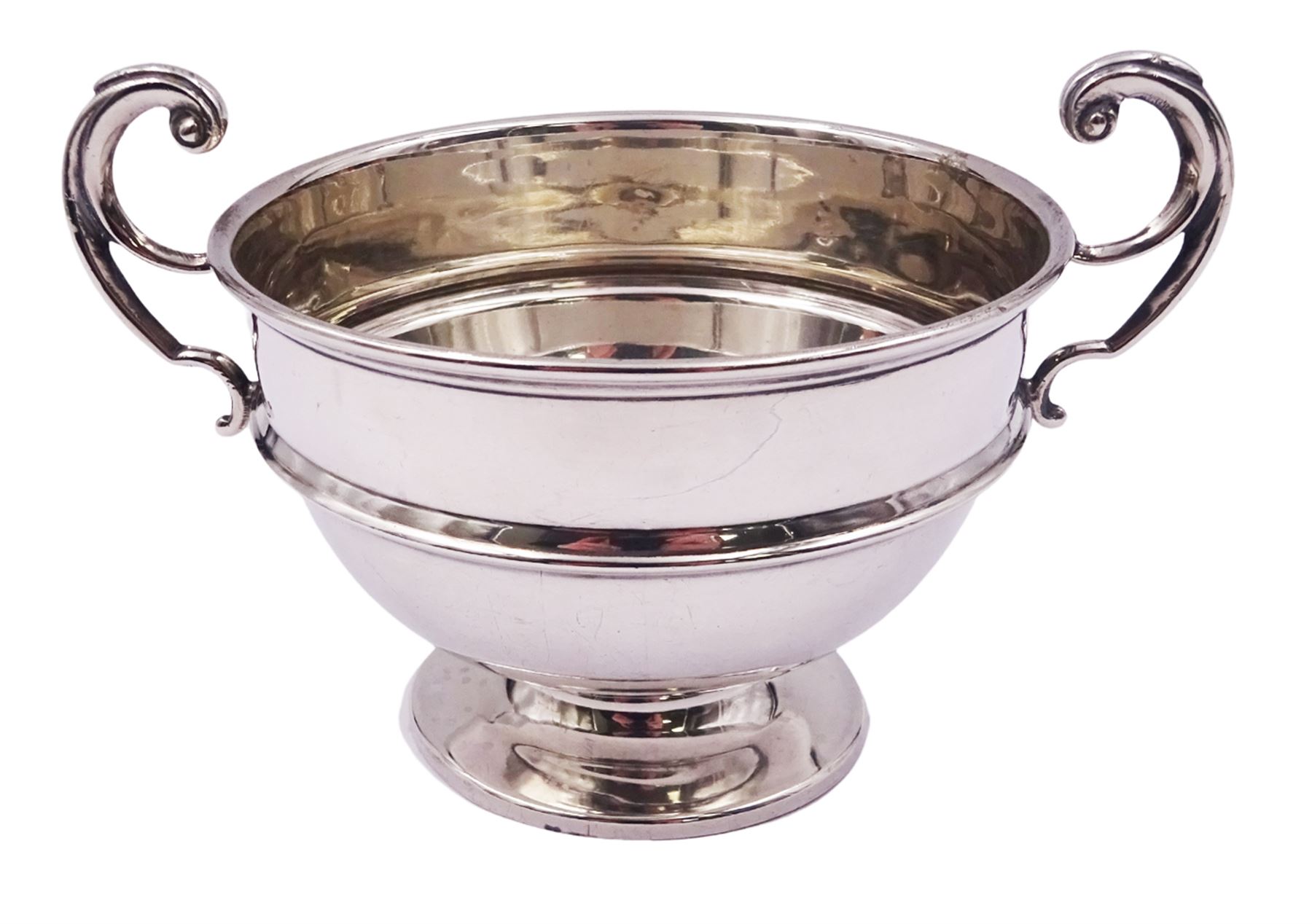1920's silver twin handled bowl, of circular form with girdle and twin flying scroll handles, upon a spreading circular foot, hallmarked James Woods & Sons, Birmingham 1921, including handles H9cm bowl D10.5cm, approximate weight 4.34 ozt (134.9 grams)