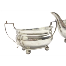  Silver three piece tea set of oblong form with gadrooned border, the teapot with ebonised handle and lift by Thomas Edward Atkins Birmingham 1915 19.1oz  