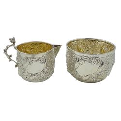 Silver milk and sugar bowl, embossed foliate and floral decoration by Goldsmiths & Silversmiths Co, 1891, approx 4.5oz