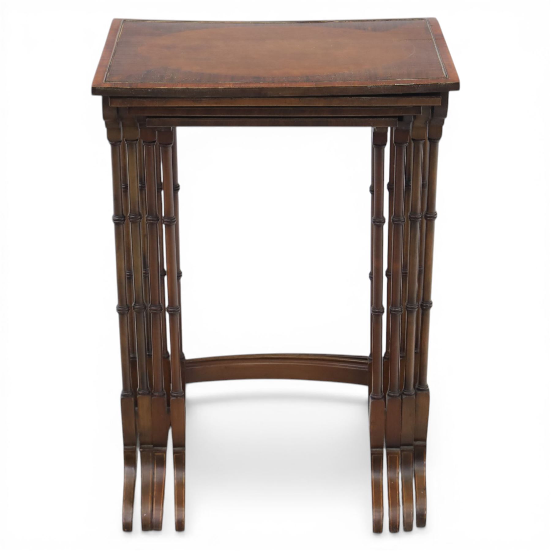 20th century mahogany quartetto nest of tables, the rectangular tops with oval inlay, upon turned knopped supports, united by a curved stretcher, raised upon outswept feet