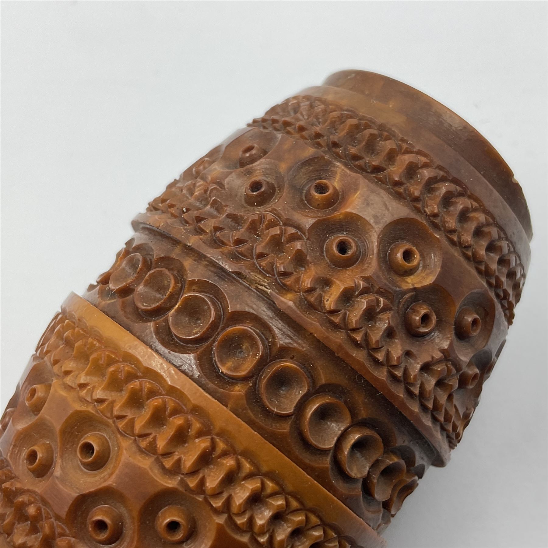 Three 19th century coquilla nut pomanders or flea catchers, two of egg shaped form and the third of barrel from with carved and pierced decoration and screw threaded join, largest H8cm