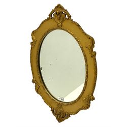 Early 20th century gilt wood and gesso wall mirror, in shaped frame decorated with foliate scrolls and cartouche pediments 