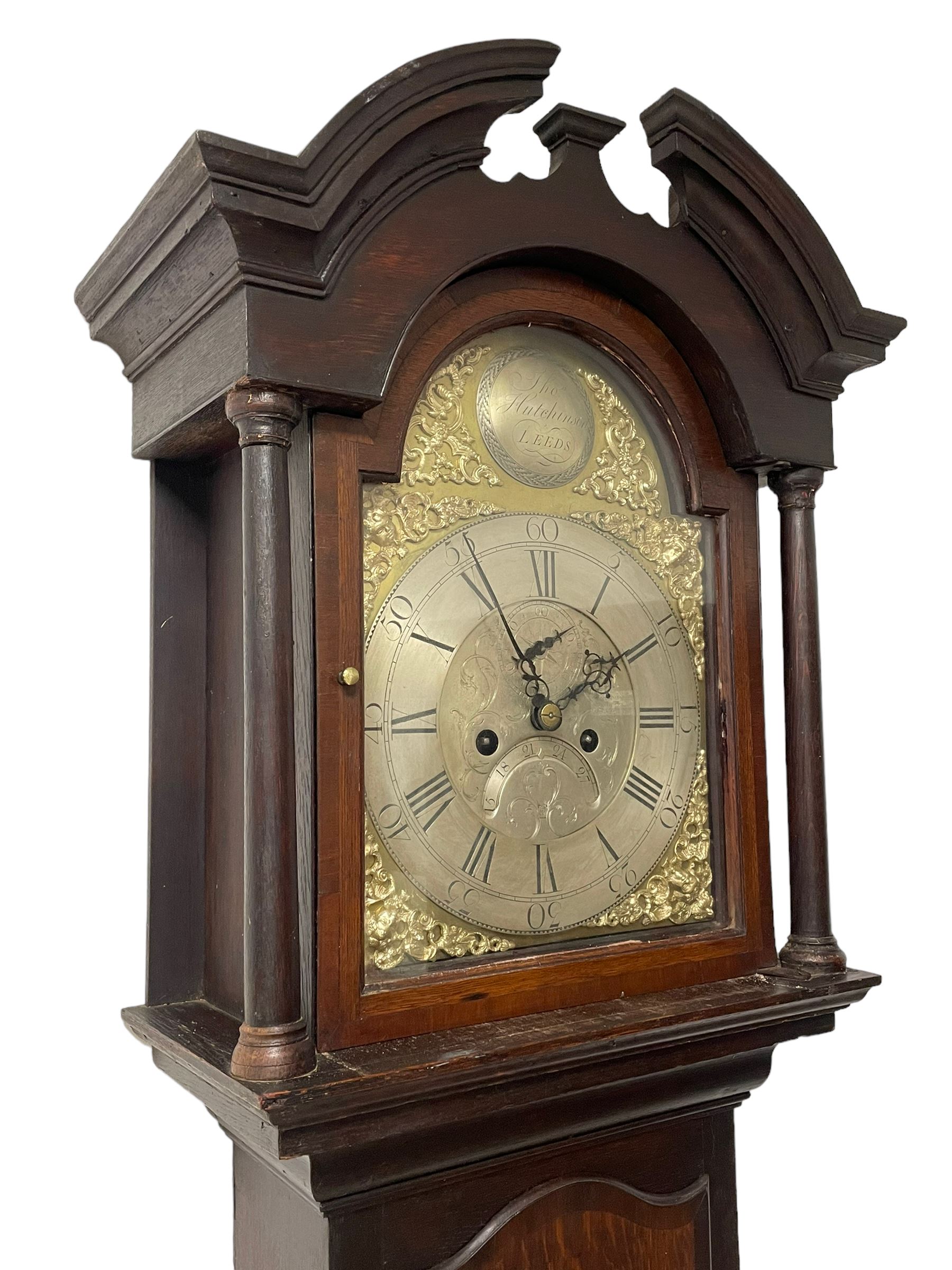 Thomas Hutchinson of Leeds - 18th century 8-day oak longcase clock with as broken arched  pediment and moulded cornice, with a conforming hood door flanked by plain turned pilasters with gesso capitals,  long trunk door with a wavy top on a square plinth with a raised panel, brass dial with cast spandrels,  engraved silvered dial centre and chapter ring with Roman numerals, five minute Arabic's and minute track, with pierced steel hands, seconds pointer,  arched calendar aperture and silvered boss engraved with the makers name to the break arch, dial pinned to a rack striking two train movement with a recoil anchor escapement. With weights and pendulum. Thomas Hutchinson is recorded as working in Leeds from 1760-90.
