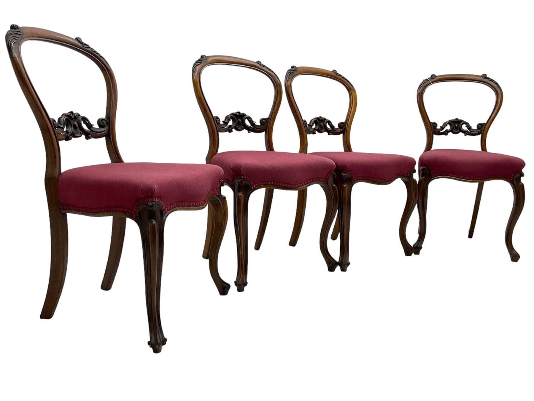 Set of six Victorian rosewood dining chairs, the balloon back carved with foliage scrolls, cartouche carved middle rail with extending scrolls, the seats upholstered in pink fabric, on carved cabriole supports with scrolled terminals 