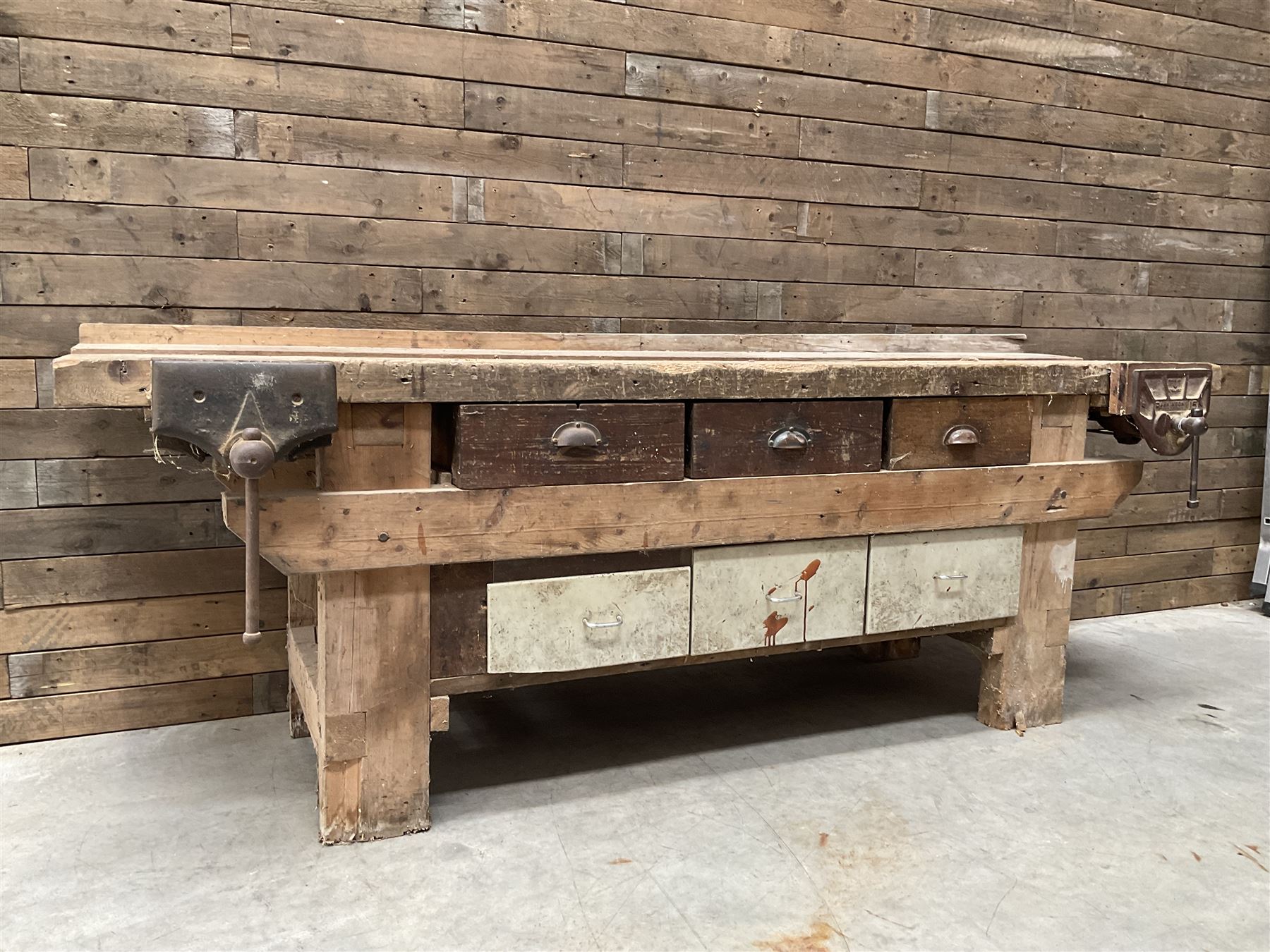 Large vintage work bench, fitted with six drawers and two vice