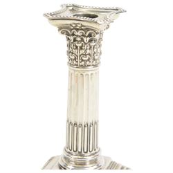 Pair of early 20th century silver Corinthian column candlesticks, upon square stepped filled bases, hallmarked Walter Latham & Son, Sheffield 1913, H16cm
