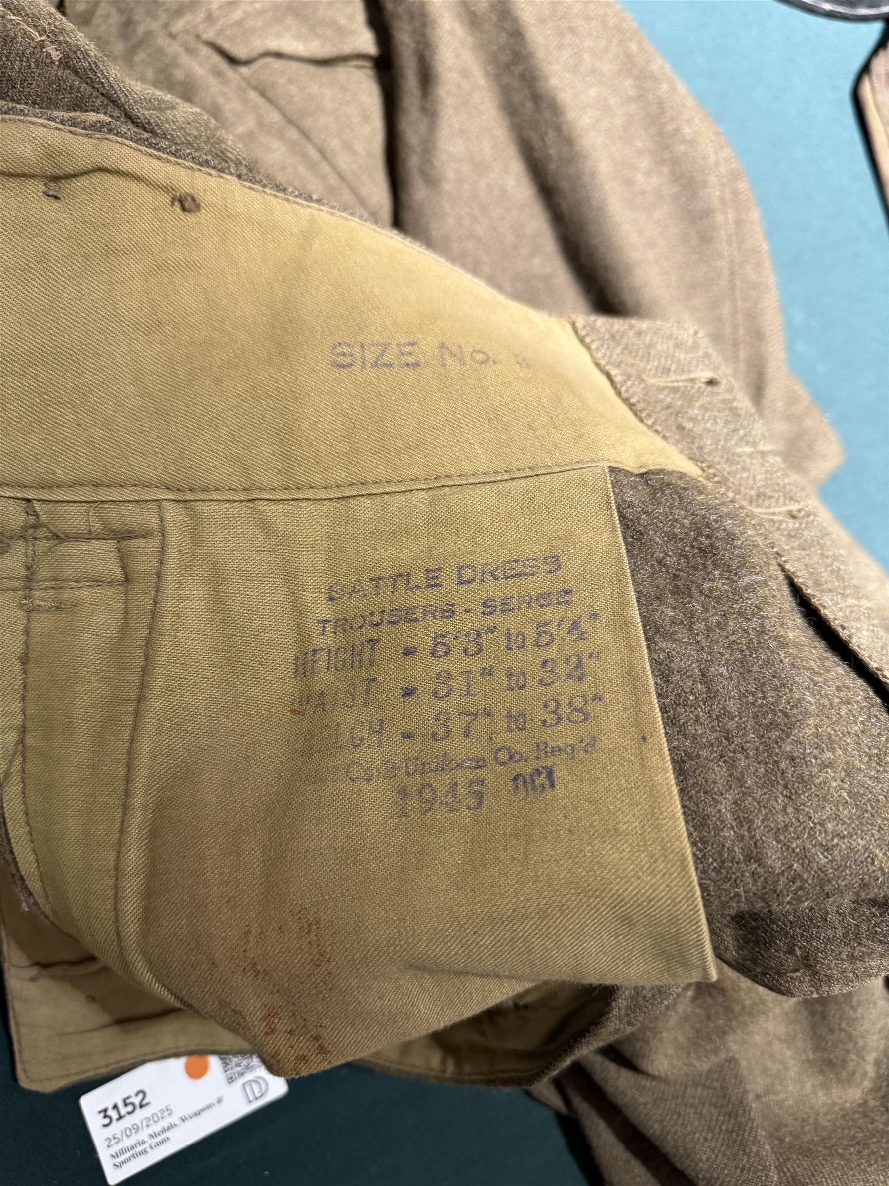 WWII British parachute regiment battle dress uniform, the jacket with shoulder title and Pegasus formation badge to the left arm, shoulder title, Pegasus formation badge and cloth wings to the right, size 3 dated 1943, the trousers size 3 dated 1945 