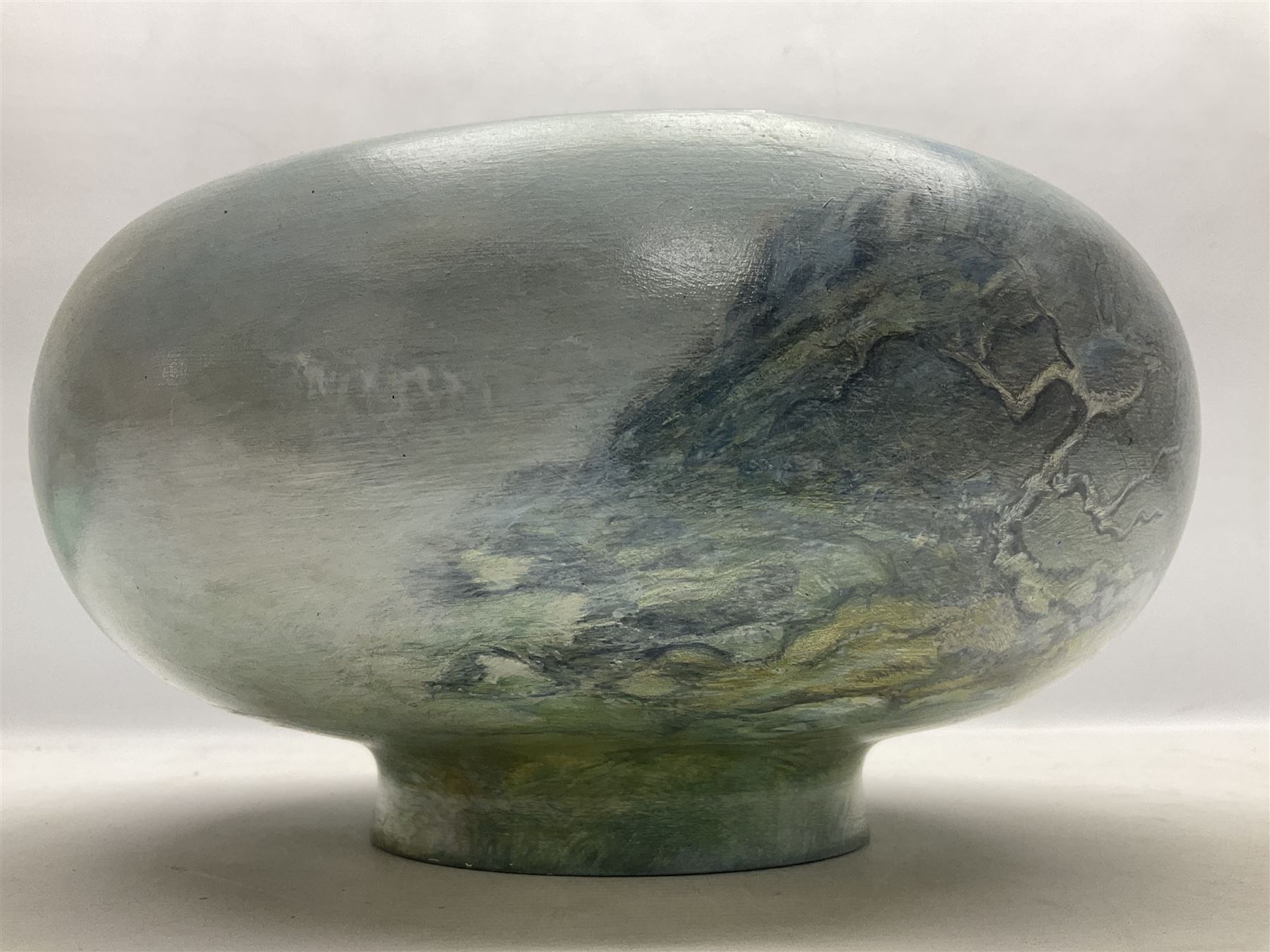 Wooden hand painted bowl, decorated with trees on a blue ground, signed Phil Crennell beneath, D28cm